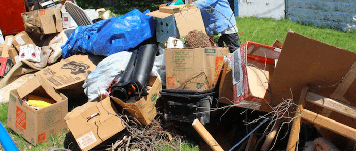 Junk Pile On The Curb With Boxes Of Unwanted Items
