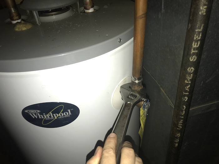 Wrench disconnecting T&P valve from old water heater