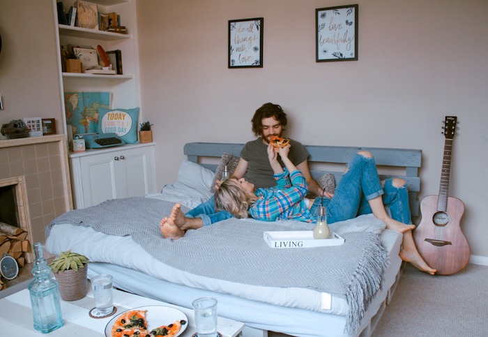 couple on bed in neutral bedroom