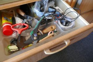 Organizing a messy junk drawer.