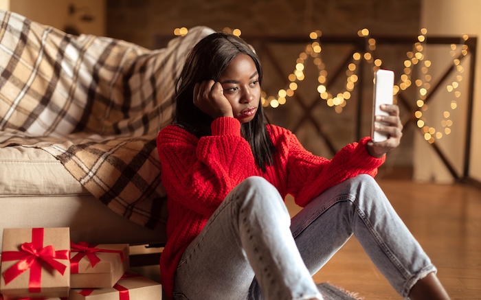 Young woman has the holiday blues and should consider decluttering.