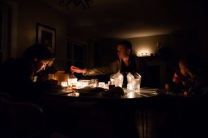Family eats a meal during a power outage