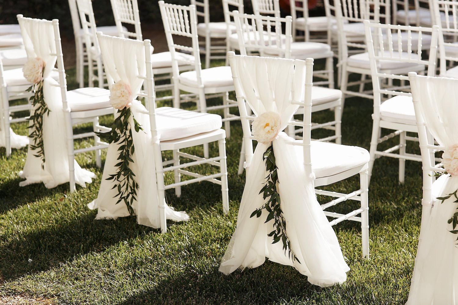 Assembled white wedding chairs