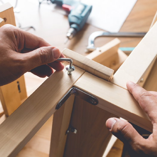 professional with tools building bookcase