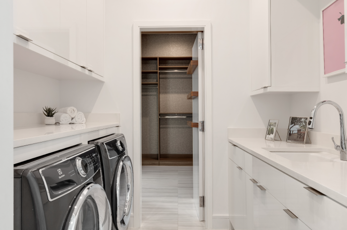 Clean and organized laundry room with wall shelves and storage baskets, laundry room organization ideas