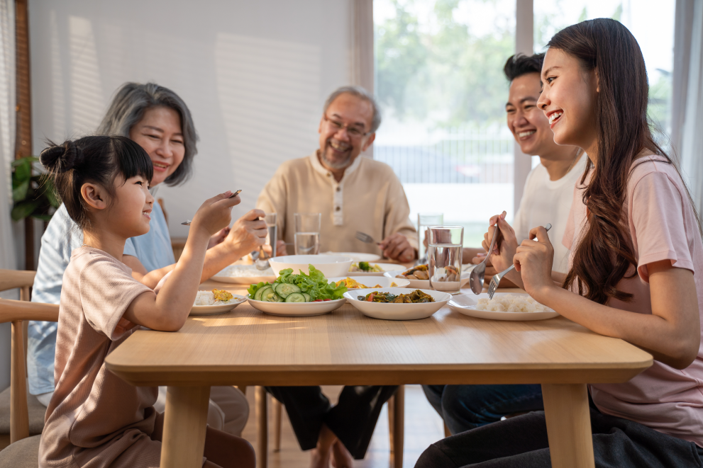 Family having dinner sitting at professionally assembled kitchen table