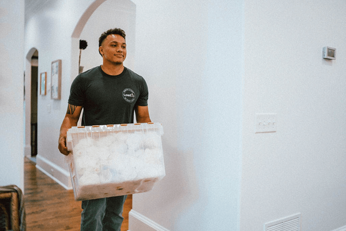 LoadUp junk hauler carrying a box of personal items from an apartment clean out