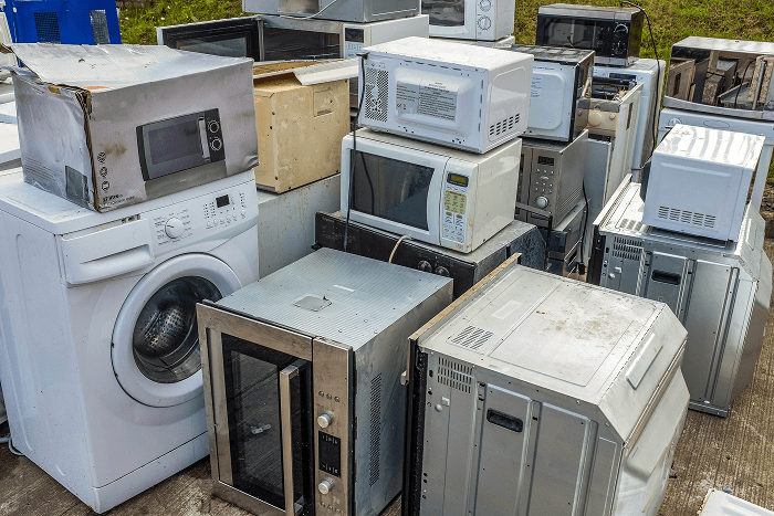Microwave being dropped off at an electronic waste recycling center.