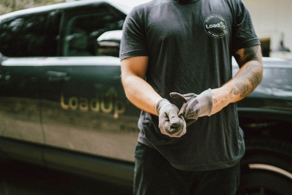 Loader putting on gloves