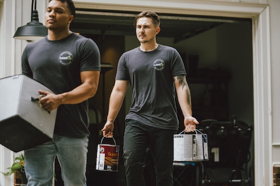 storage unit pros carrying items out of a storage unit