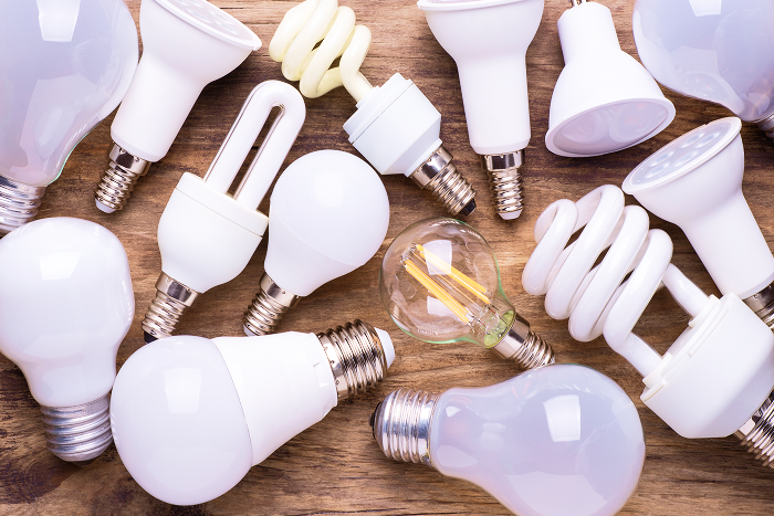 Different types of old lights on a table to be sorted and disposed of