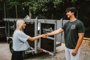 Junk removal professional shaking hands with a customer after a job well done