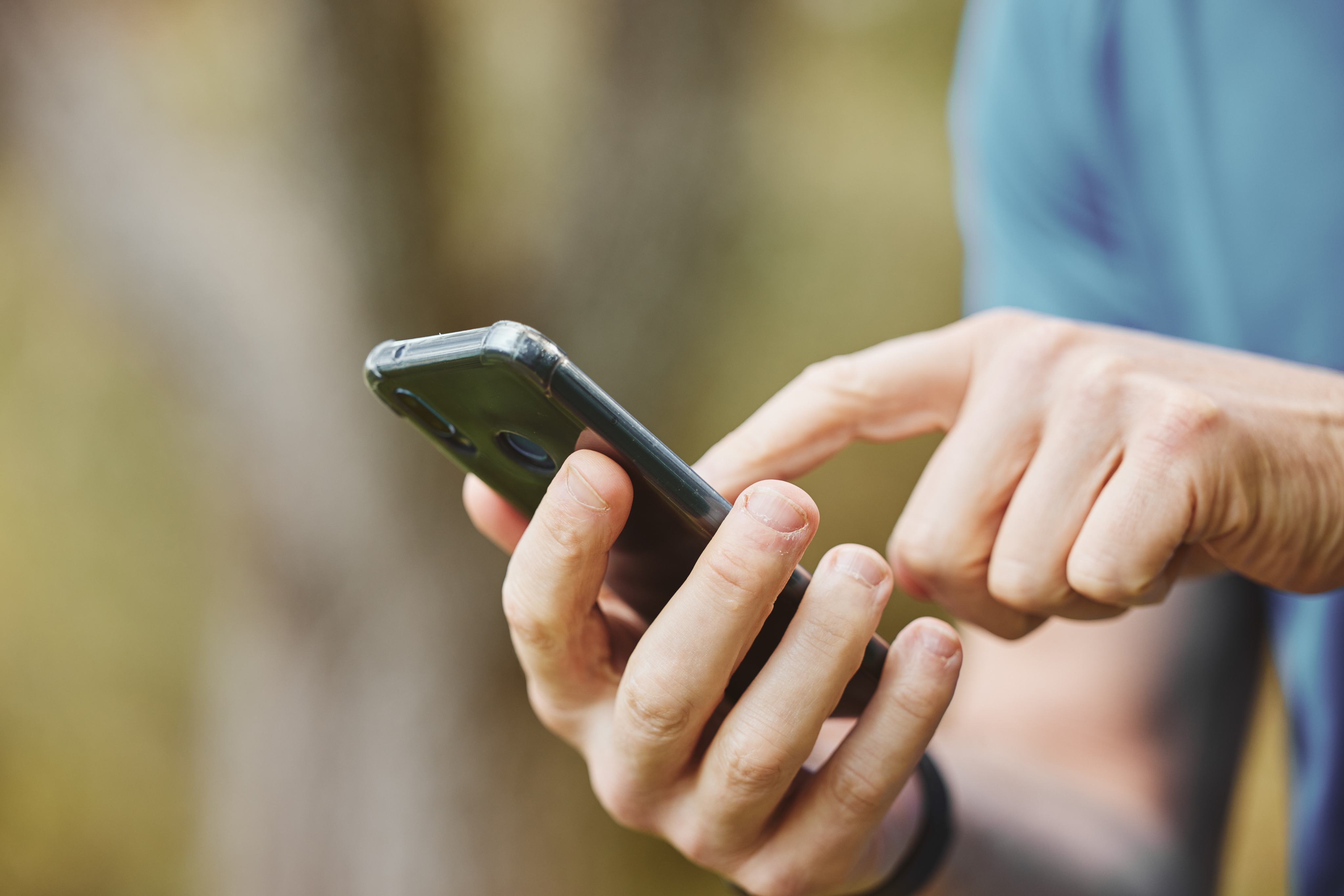 Man on smartphone downloading LoadUp's Loader app