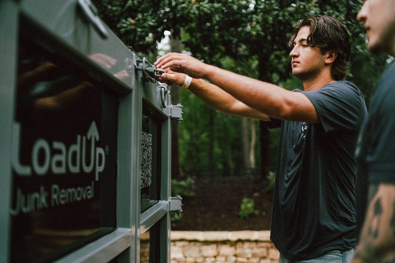Two Loaders securing their junk trailer after a removal job