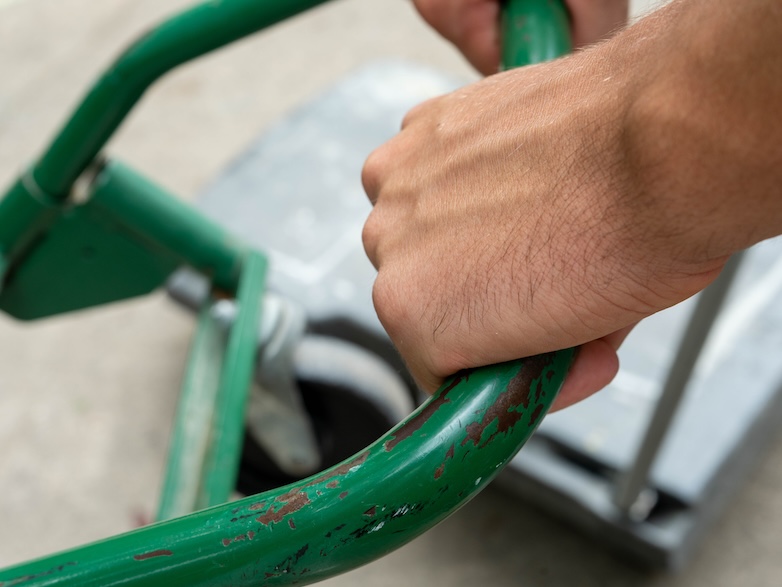 Junk removal professional carrying dolly