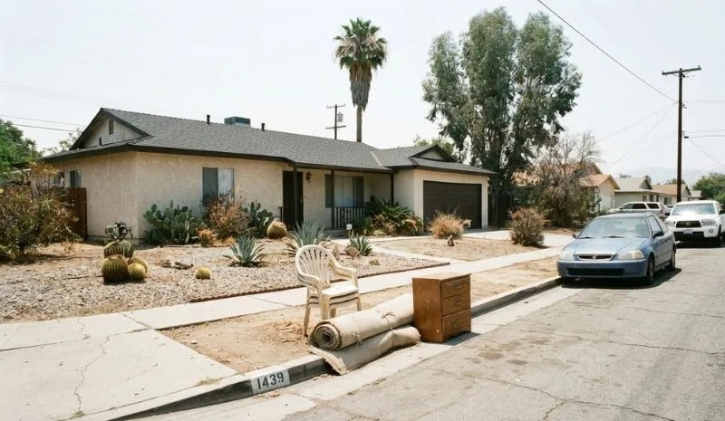 Bulk item pile including patio furniture staged at the curb in front home ready for pickup