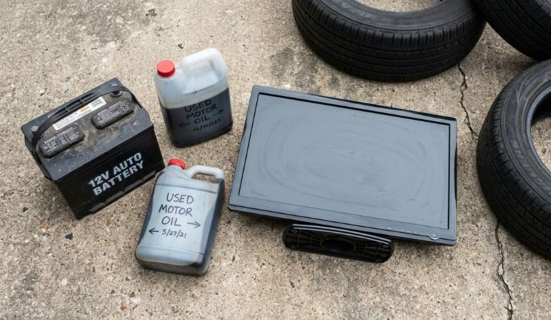 BOAT-E program accepted items: car battery, motor oil, monitor, and tires grouped on a concrete surface